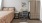 bedroom with a bed, desk and chair, and armoire