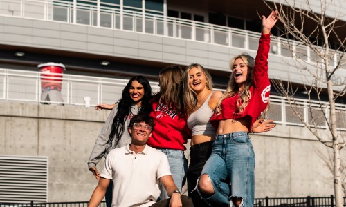 students smiling in front of a building 