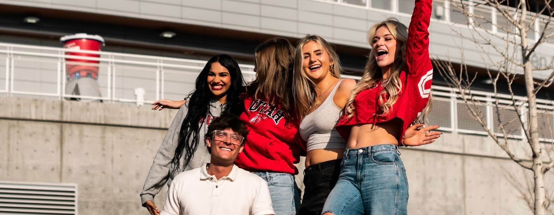 students smiling in front of a building 